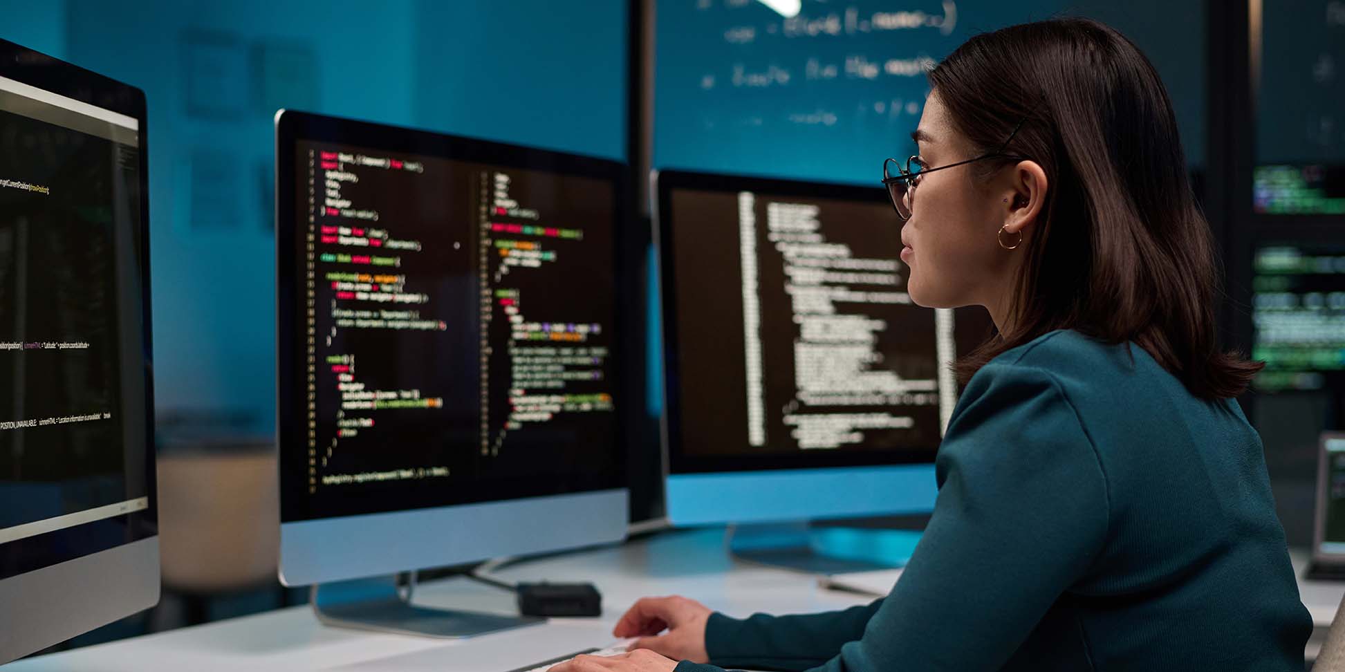 Girl as IT Developer Writing Code in Blue Light