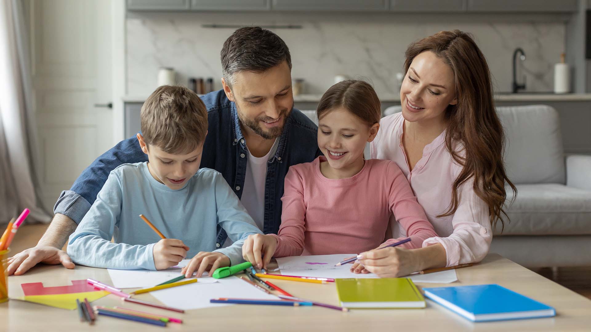 Father and mother helping kids study at home